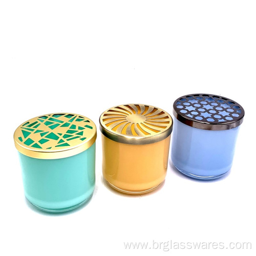 Colored glass candle jar with hollow-out type lid